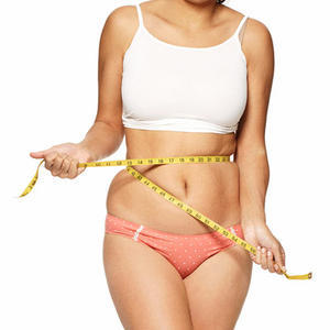 Overweight girl measures waist